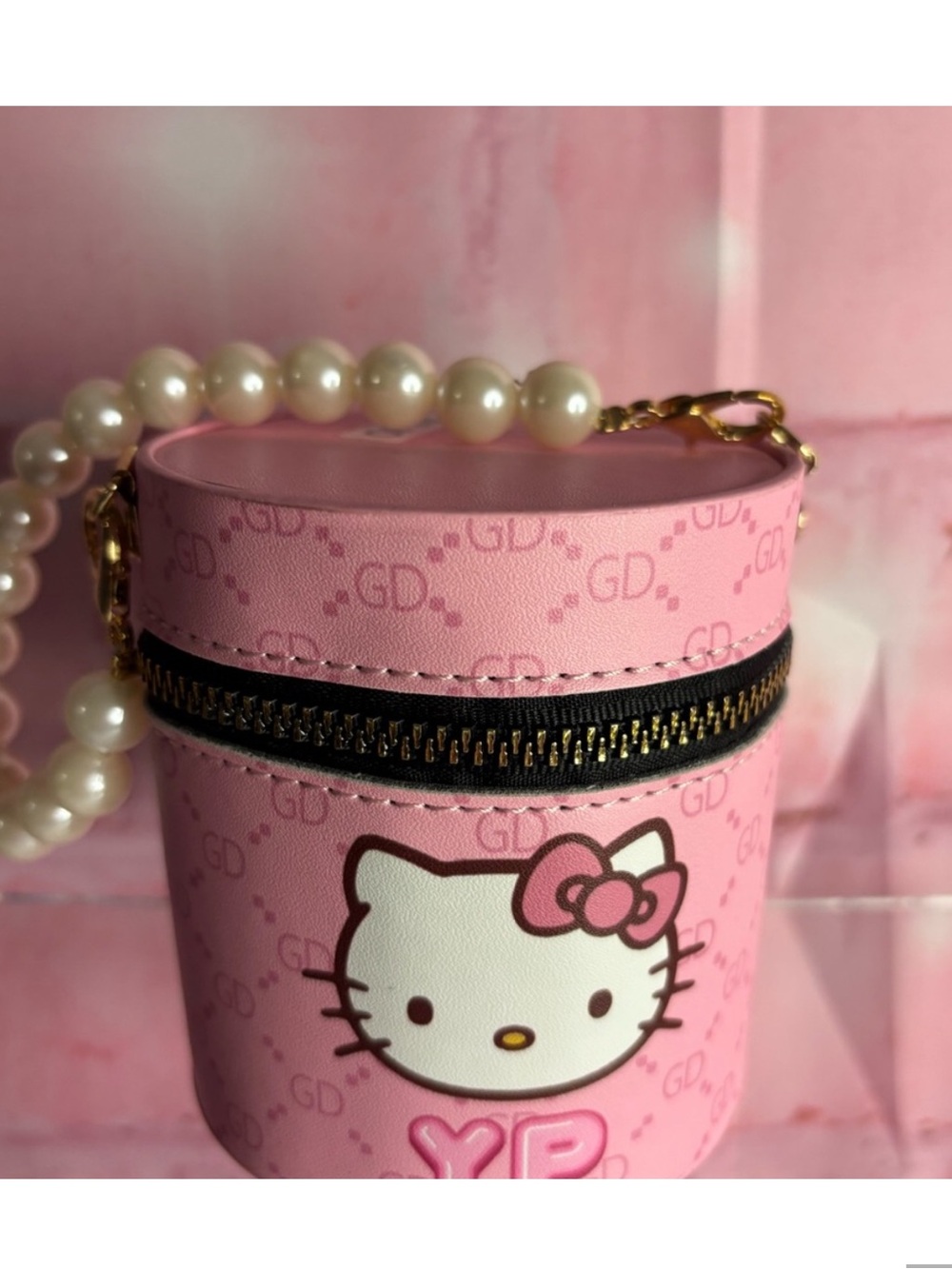 Pink Hello Kitty Accessory Pouch with Pearl Handle and full of lip gloss